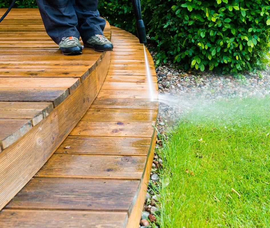 man is cleaning a Deck with pressure washing in Melbourne, FL